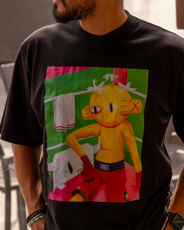 Defeated Tee by Naji Al-Ali LMNBCK — black cotton t-shirt with bold LMNBCK illustrated graphic artwork