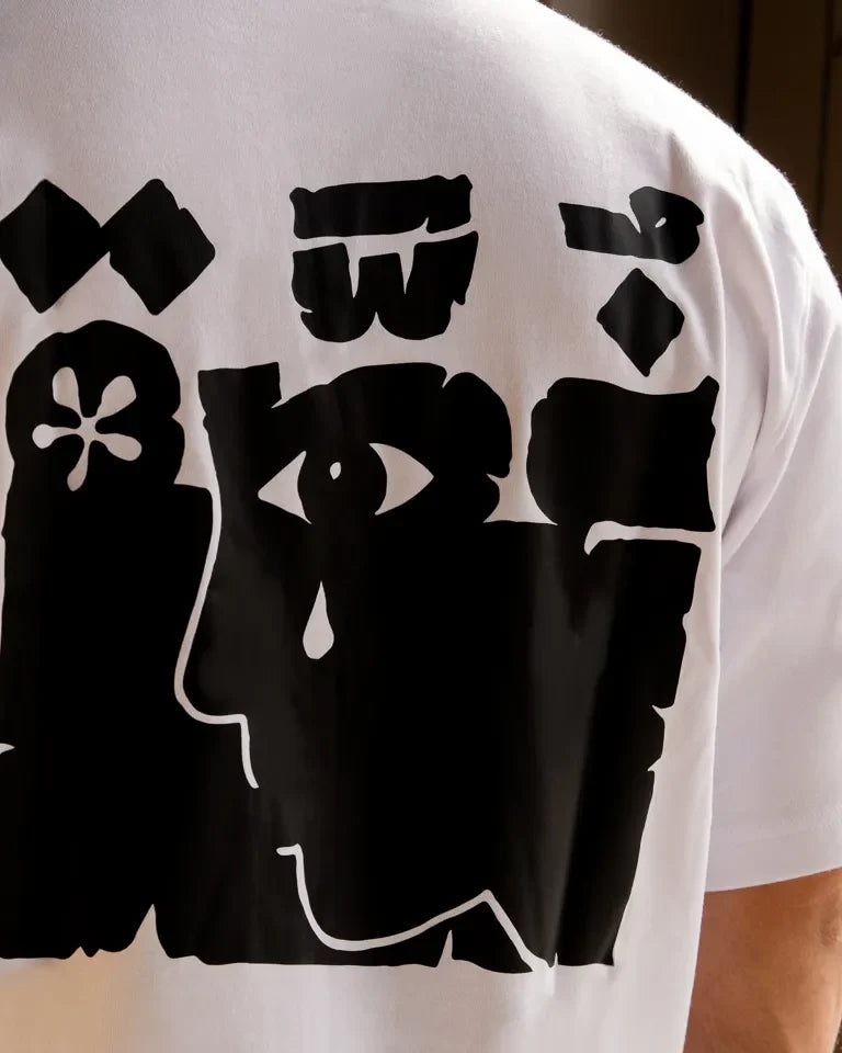 Ghosseh Tee by Ibrahim Zaki — white cotton t-shirt with embroidered Arabic calligraphy expressing layered emotion