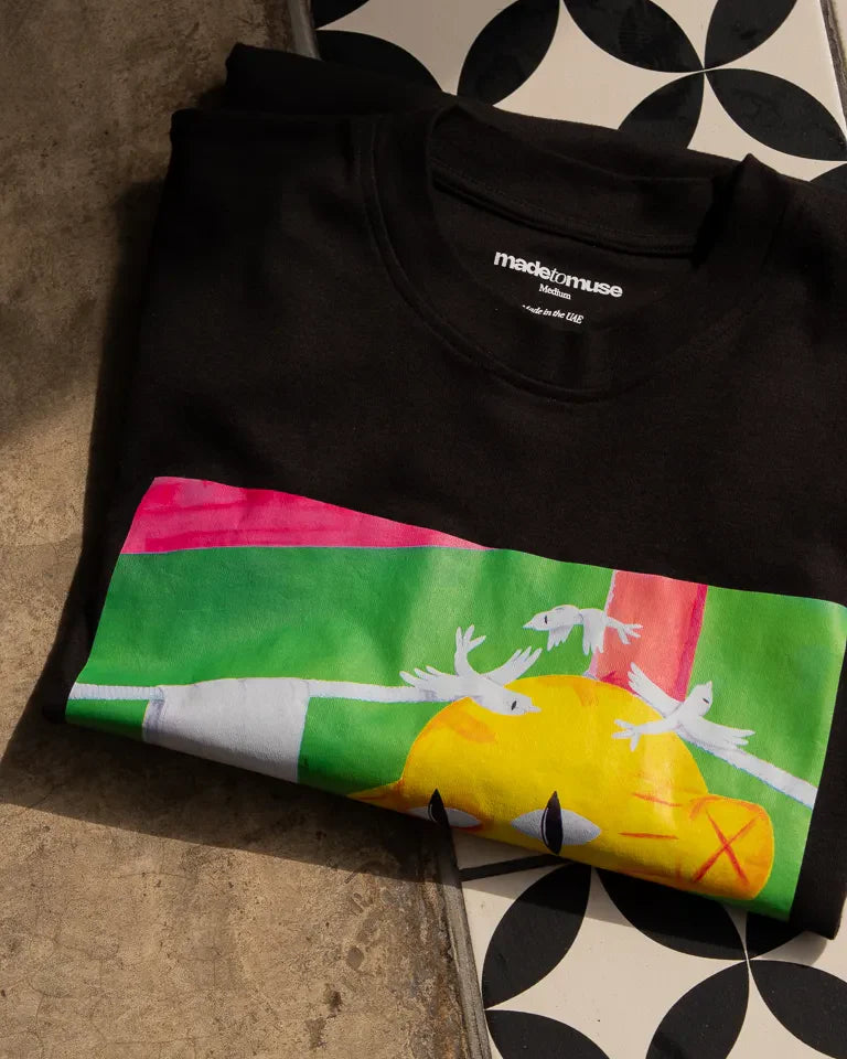 Defeated Tee by Naji Al-Ali LMNBCK — black cotton t-shirt with bold LMNBCK illustrated graphic artwork