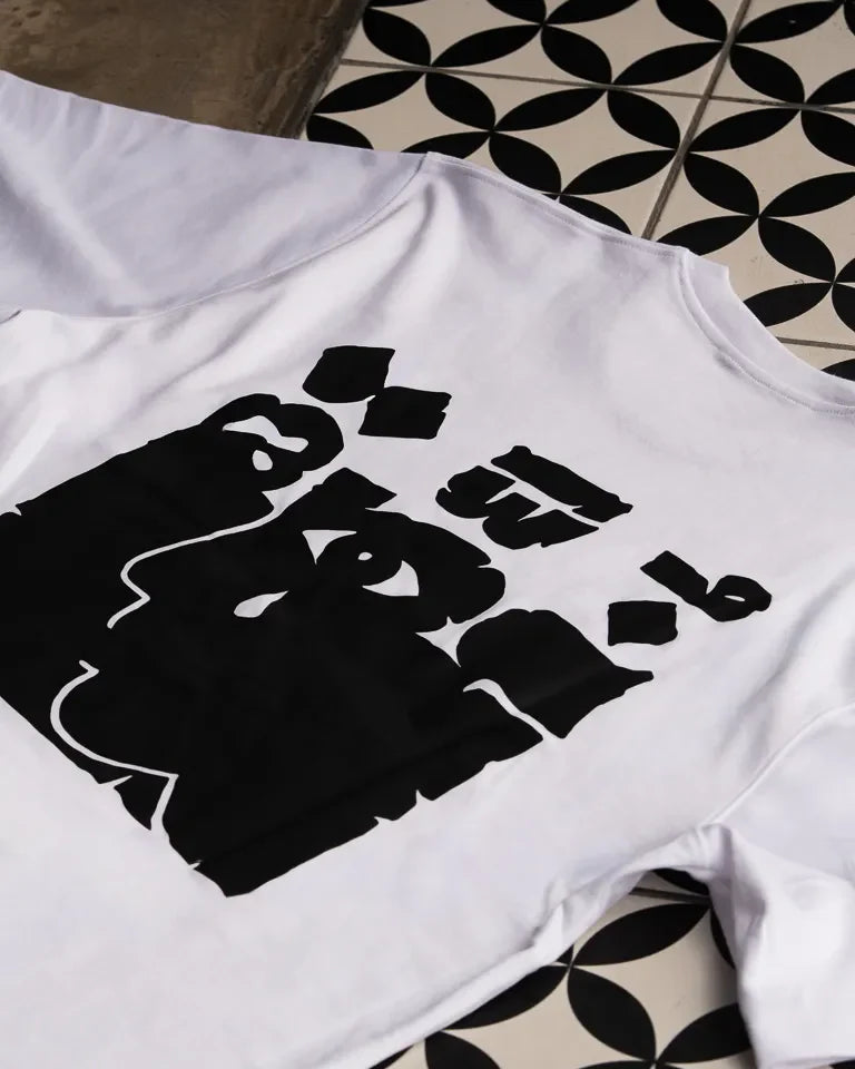 Ghosseh Tee by Ibrahim Zaki — white cotton t-shirt with embroidered Arabic calligraphy expressing layered emotion
