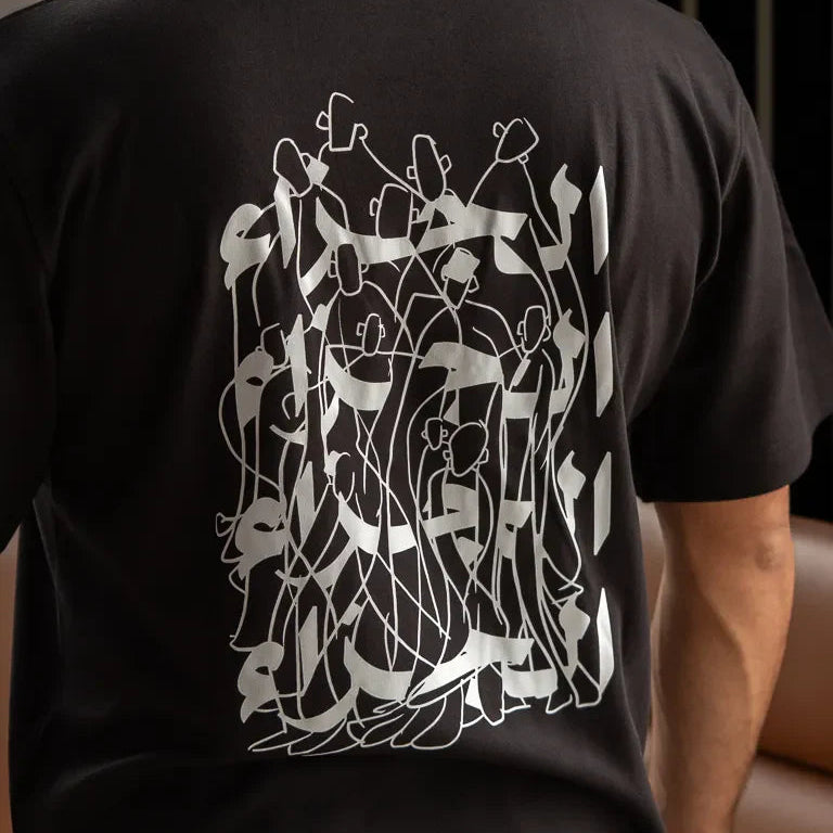 Jazaa' Tee by Ibrahim Zaki — white cotton t-shirt with embroidered Arabic calligraphy and graphic back print