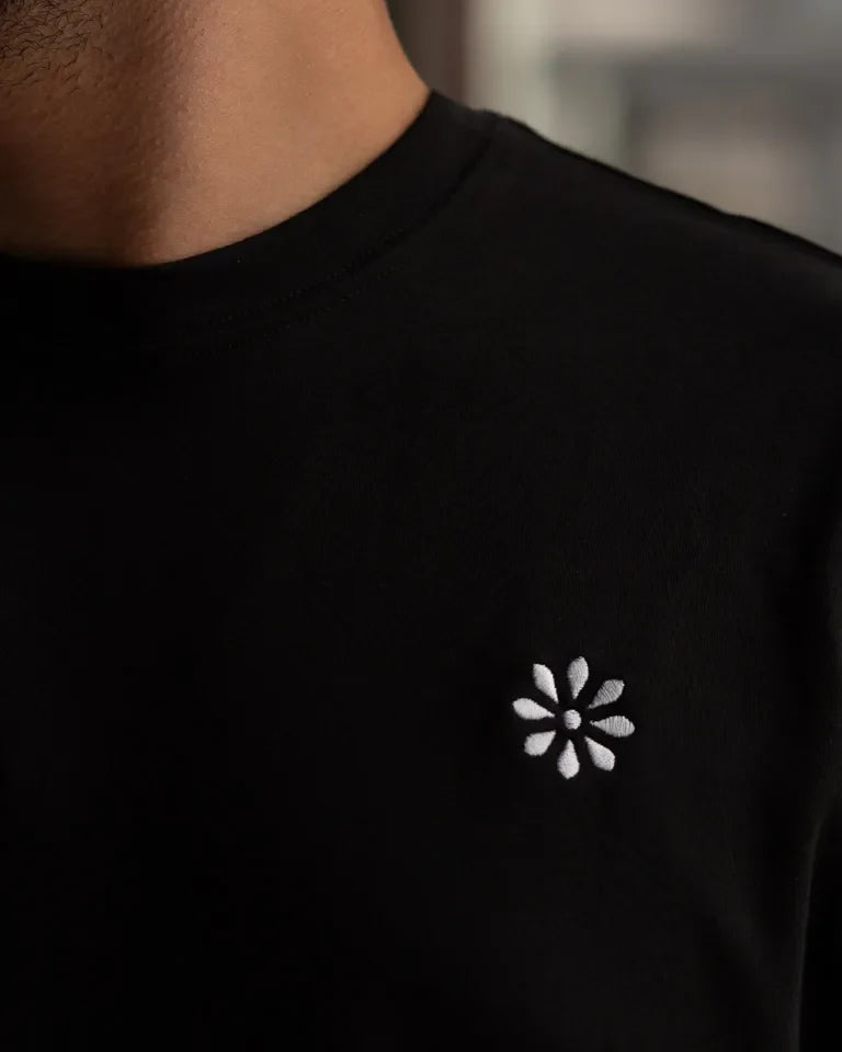 Jazaa' Tee by Ibrahim Zaki — white cotton t-shirt with embroidered Arabic calligraphy and graphic back print
