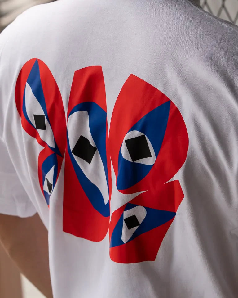 Inside Outside Tee by Wissam Shawkat — white cotton t-shirt with bold red and blue Arabic calligraphy graphic