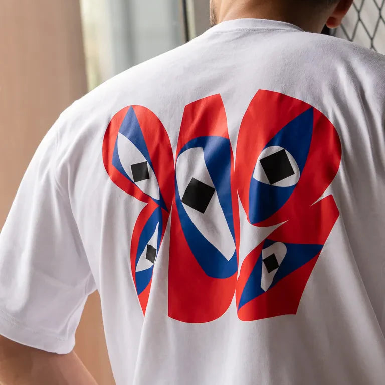 Inside Outside Tee by Wissam Shawkat — white cotton t-shirt with bold red and blue Arabic calligraphy graphic