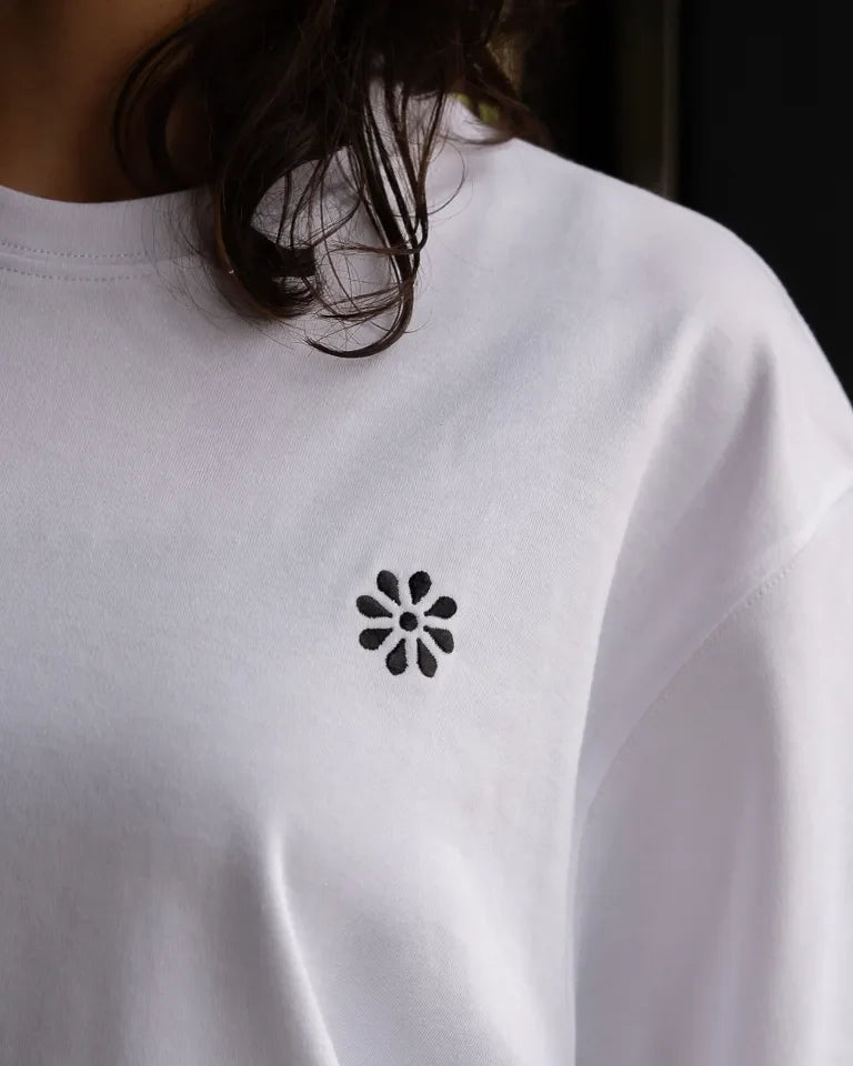Ghosseh Tee by Ibrahim Zaki — white cotton t-shirt with embroidered Arabic calligraphy expressing layered emotion