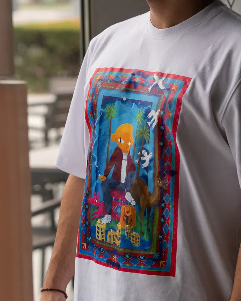 Traveler Tee by Naji Al-Ali LMNBCK — white cotton t-shirt with vibrant illustrated LMNBCK character artwork