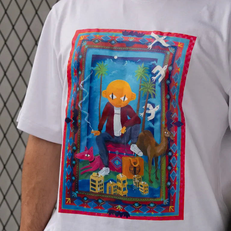Traveler Tee by Naji Al-Ali LMNBCK — white cotton t-shirt with vibrant illustrated LMNBCK character artwork