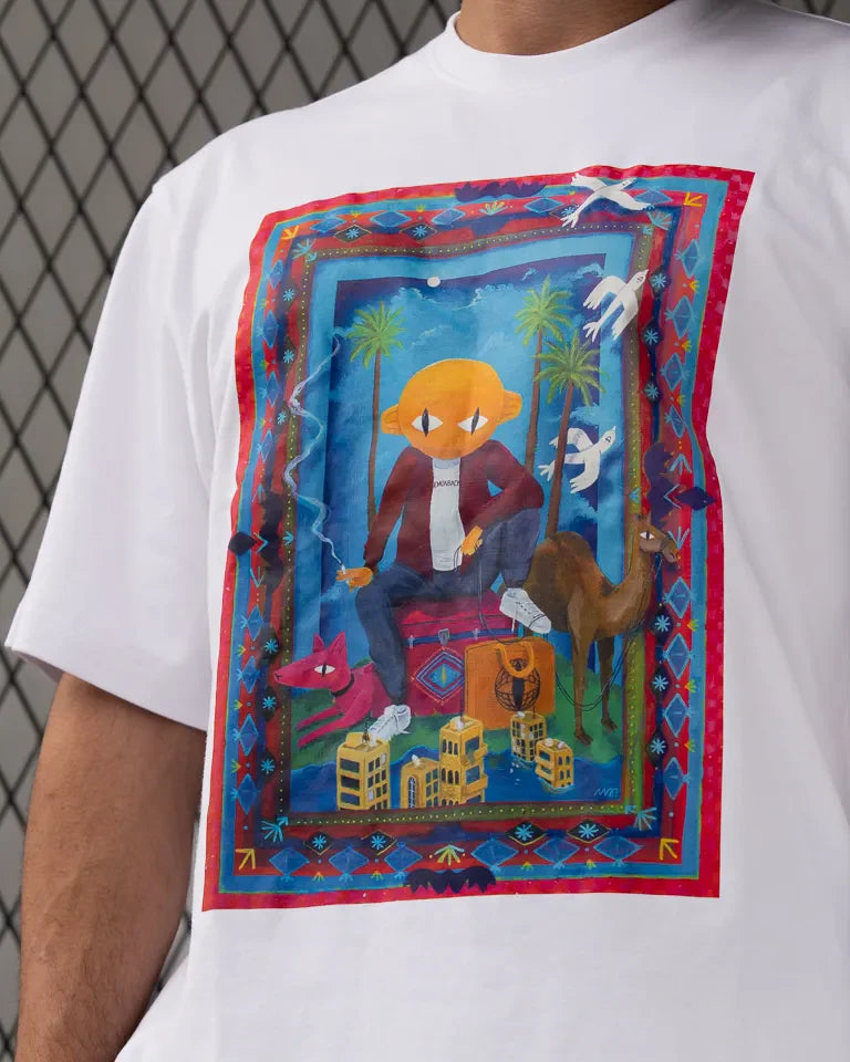 Traveler Tee by Naji Al-Ali LMNBCK — white cotton t-shirt with vibrant illustrated LMNBCK character artwork
