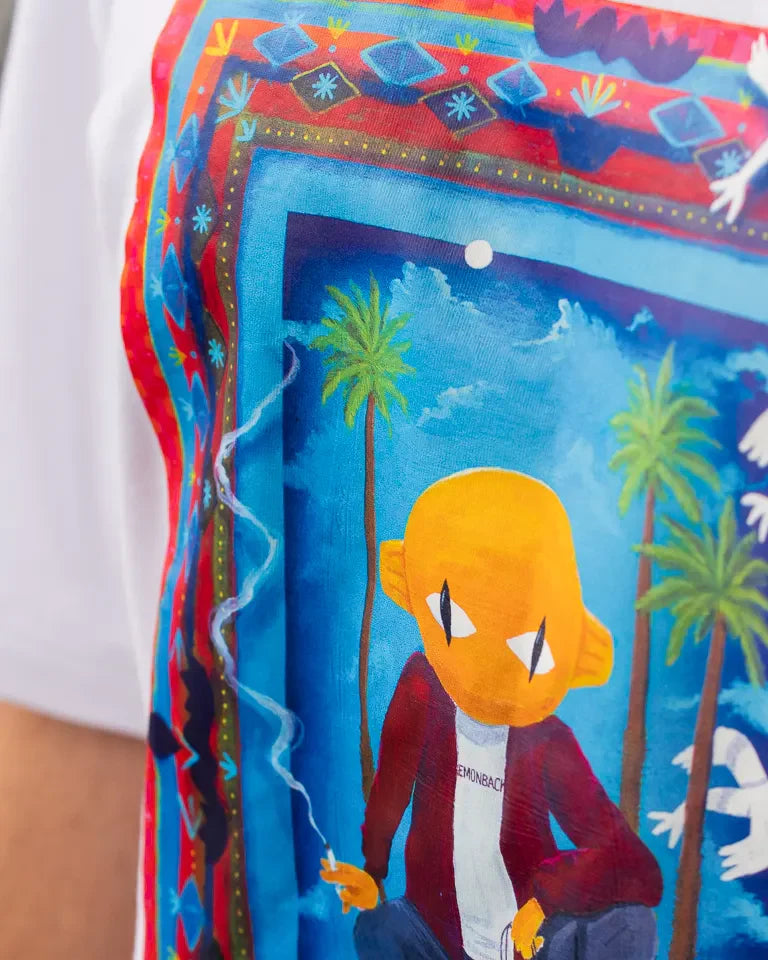 Traveler Tee by Naji Al-Ali LMNBCK — white cotton t-shirt with vibrant illustrated LMNBCK character artwork