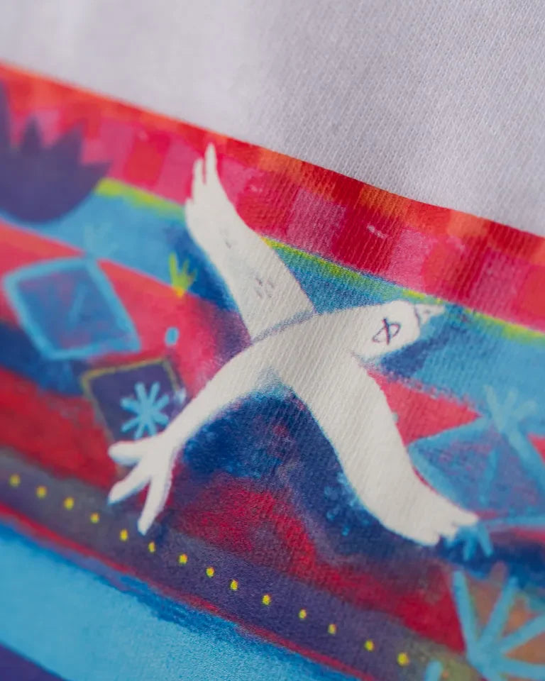 Traveler Tee by Naji Al-Ali LMNBCK — white cotton t-shirt with vibrant illustrated LMNBCK character artwork