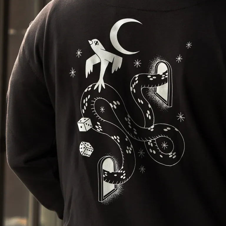 Snake Eyes Hoodie by Naji Al-Ali LMNBCK — black premium cotton hoodie with monochrome LMNBCK graphic illustration