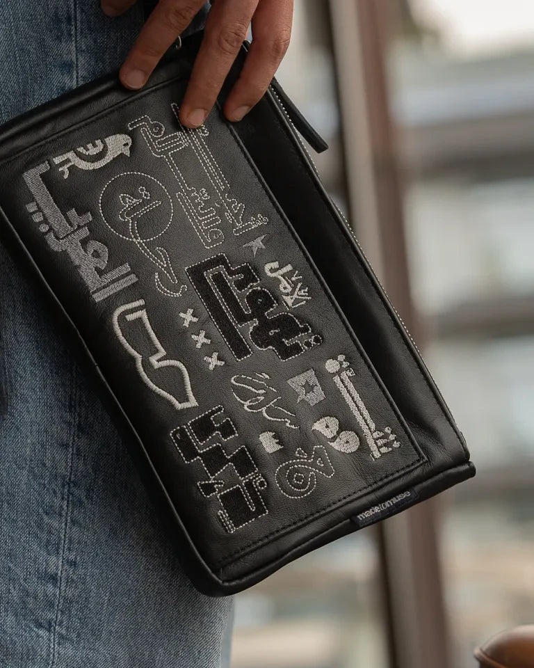 Fragments Leather Pouch by Ibrahim Zaki — handmade calfskin leather pouch with embroidered Arabic calligraphy