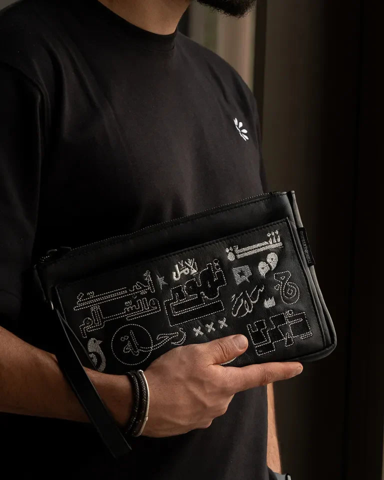 Fragments Leather Pouch by Ibrahim Zaki — handmade calfskin leather pouch with embroidered Arabic calligraphy