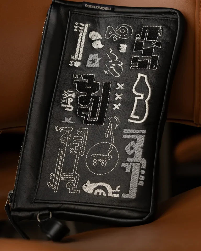 Fragments Leather Pouch by Ibrahim Zaki — handmade calfskin leather pouch with embroidered Arabic calligraphy
