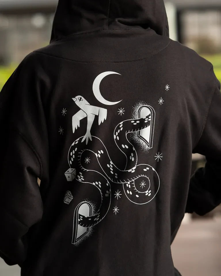 Snake Eyes Hoodie by Naji Al-Ali LMNBCK — black premium cotton hoodie with monochrome LMNBCK graphic illustration