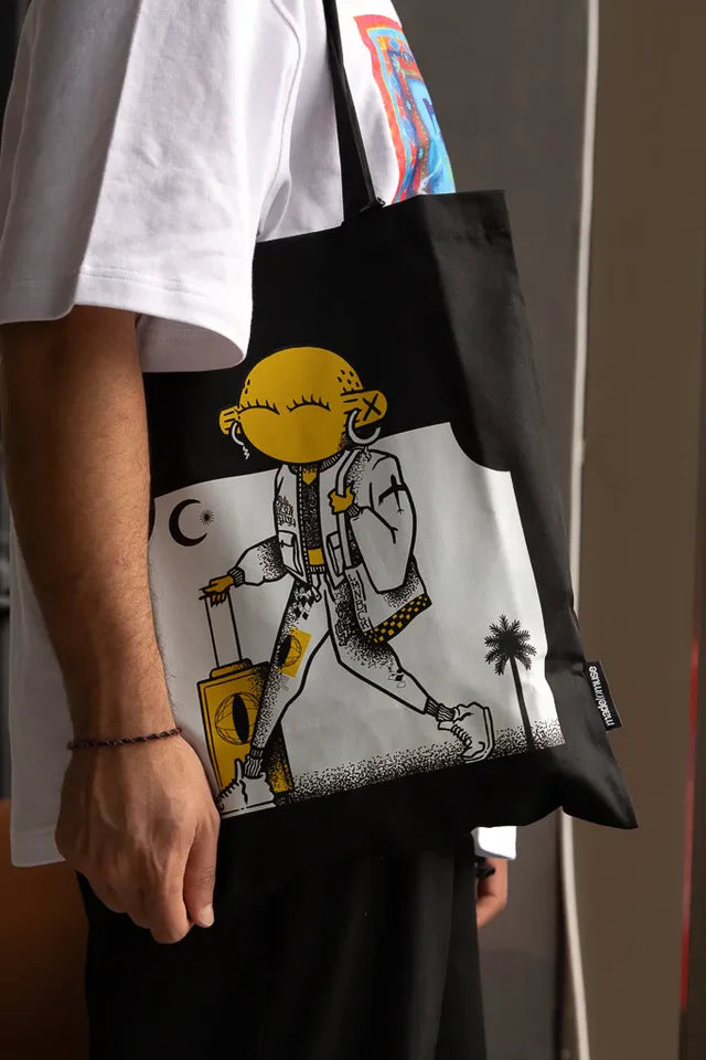 Laymona Travel Tote Bag by Naji Al-Ali LMNBCK — black canvas tote with bold illustrated LMNBCK character design