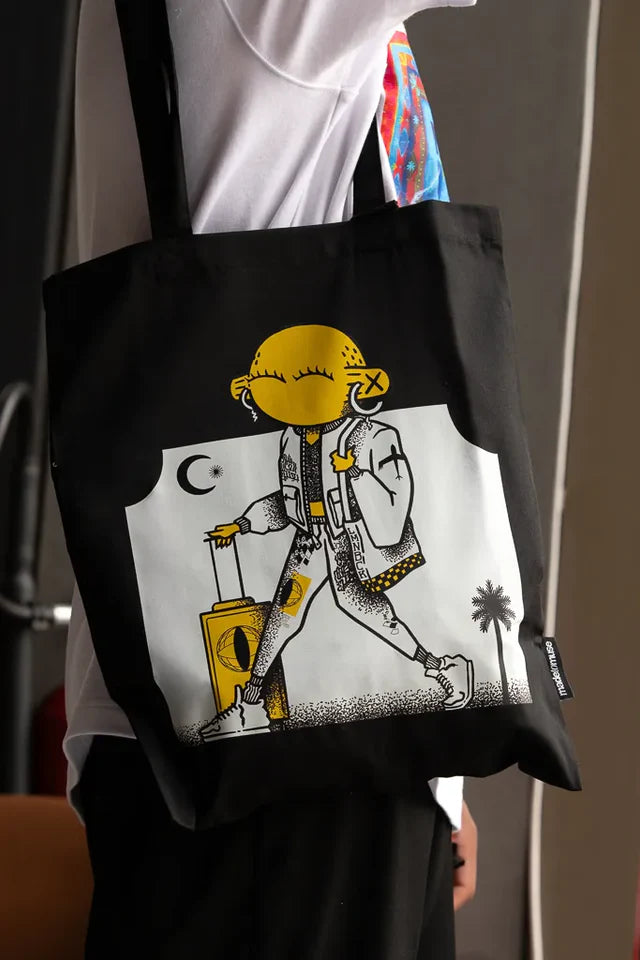 Laymona Travel Tote Bag by Naji Al-Ali LMNBCK — black canvas tote with bold illustrated LMNBCK character design