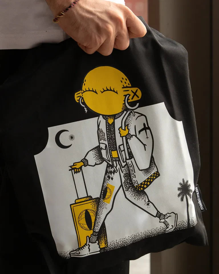 Laymona Travel Tote Bag by Naji Al-Ali LMNBCK — black canvas tote with bold illustrated LMNBCK character design