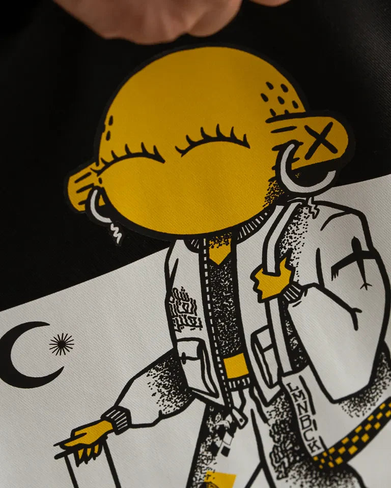 Laymona Travel Tote Bag by Naji Al-Ali LMNBCK — black canvas tote with bold illustrated LMNBCK character design