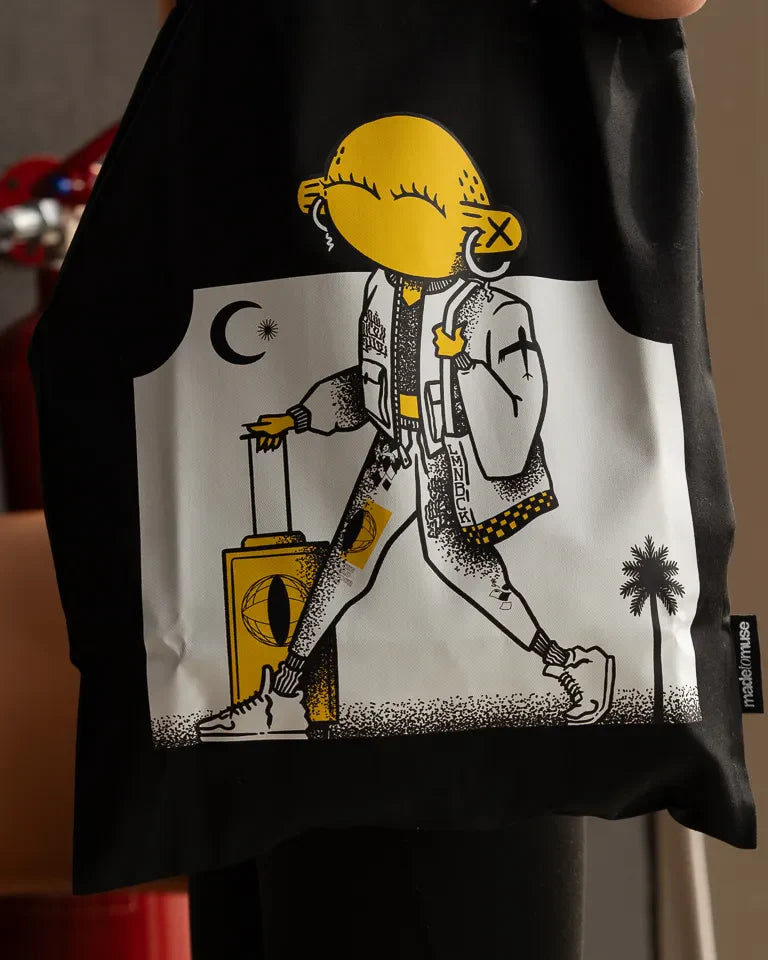 Laymona Travel Tote Bag by Naji Al-Ali LMNBCK — black canvas tote with bold illustrated LMNBCK character design