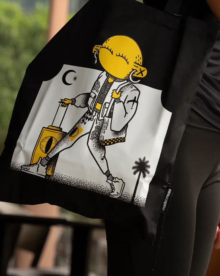 Laymona Travel Tote Bag by Naji Al-Ali LMNBCK — black canvas tote with bold illustrated LMNBCK character design
