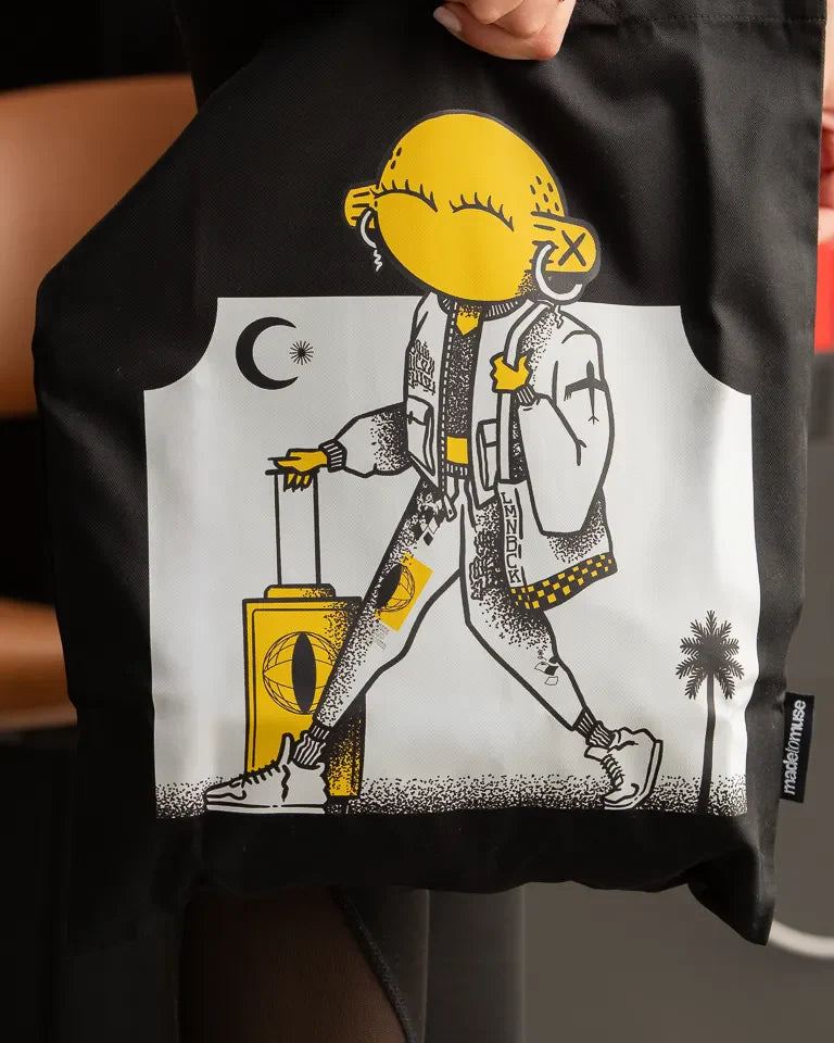 Laymona Travel Tote Bag by Naji Al-Ali LMNBCK — black canvas tote with bold illustrated LMNBCK character design
