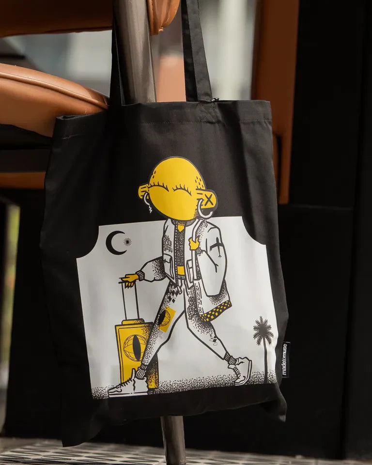 Laymona Travel Tote Bag by Naji Al-Ali LMNBCK — black canvas tote with bold illustrated LMNBCK character design