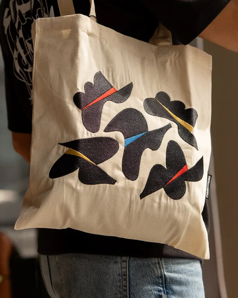 Together Tote Bag by Wissam Shawkat — natural canvas tote with embroidered Arabic calligraphy in black, red, blue, and gold