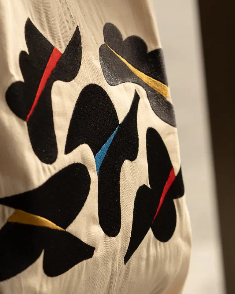 Together Tote Bag by Wissam Shawkat — natural canvas tote with embroidered Arabic calligraphy in black, red, blue, and gold