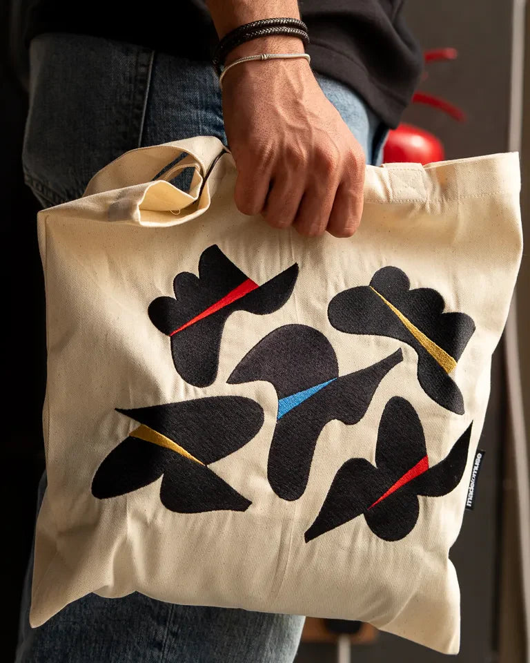Together Tote Bag by Wissam Shawkat — natural canvas tote with embroidered Arabic calligraphy in black, red, blue, and gold