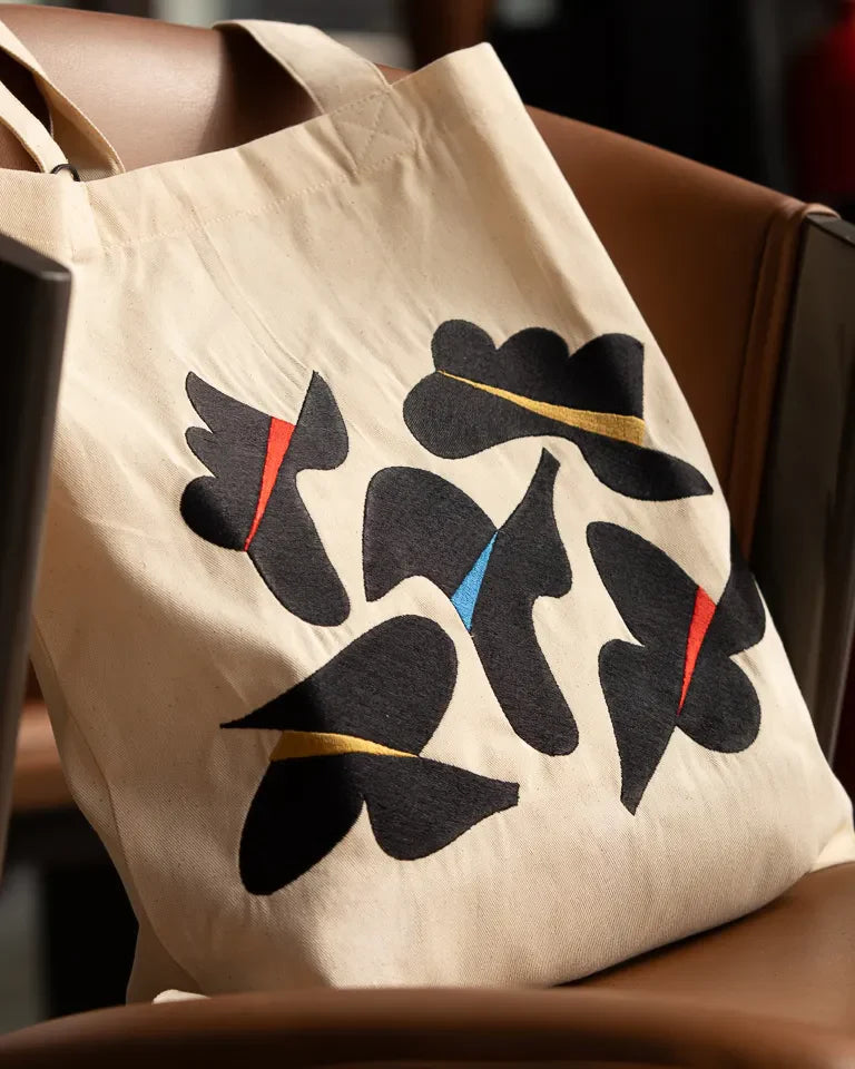 Together Tote Bag by Wissam Shawkat — natural canvas tote with embroidered Arabic calligraphy in black, red, blue, and gold