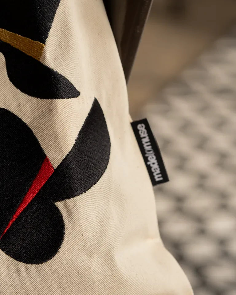 Together Tote Bag by Wissam Shawkat — natural canvas tote with embroidered Arabic calligraphy in black, red, blue, and gold