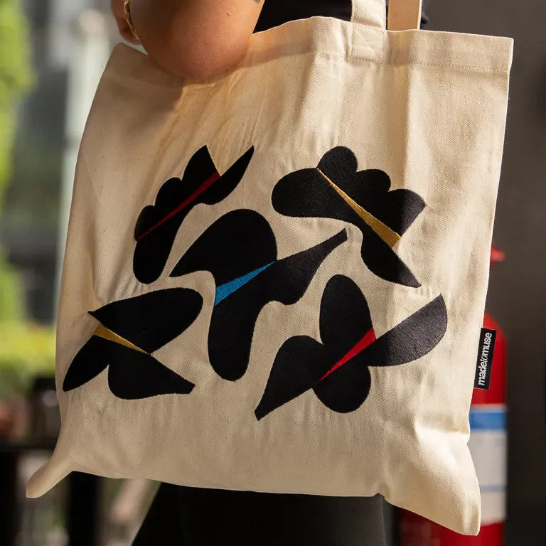 Together Tote Bag by Wissam Shawkat — natural canvas tote with embroidered Arabic calligraphy in black, red, blue, and gold