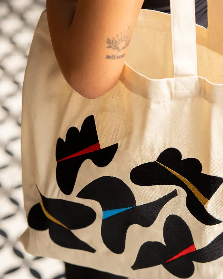 Together Tote Bag by Wissam Shawkat — natural canvas tote with embroidered Arabic calligraphy in black, red, blue, and gold