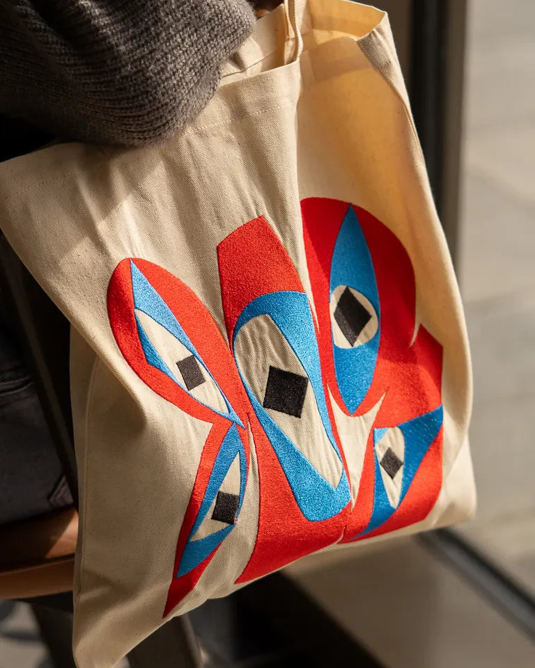 Inside Outside Tote Bag by Wissam Shawkat — natural canvas tote with embroidered bold red and blue Arabic calligraphy