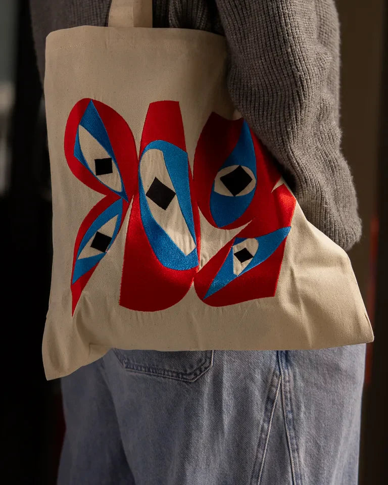 Inside Outside Tote Bag by Wissam Shawkat — natural canvas tote with embroidered bold red and blue Arabic calligraphy