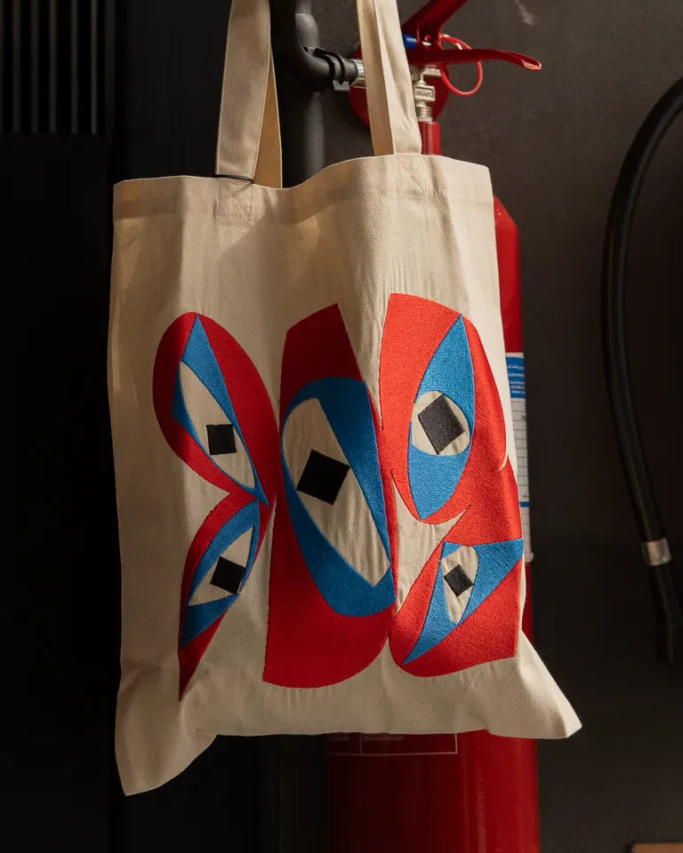 Inside Outside Tote Bag by Wissam Shawkat — natural canvas tote with embroidered bold red and blue Arabic calligraphy