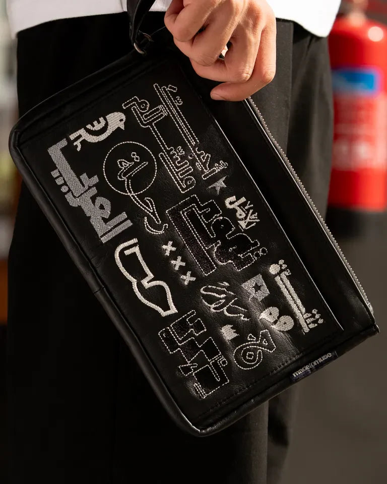Fragments Leather Pouch by Ibrahim Zaki — handmade calfskin leather pouch with embroidered Arabic calligraphy