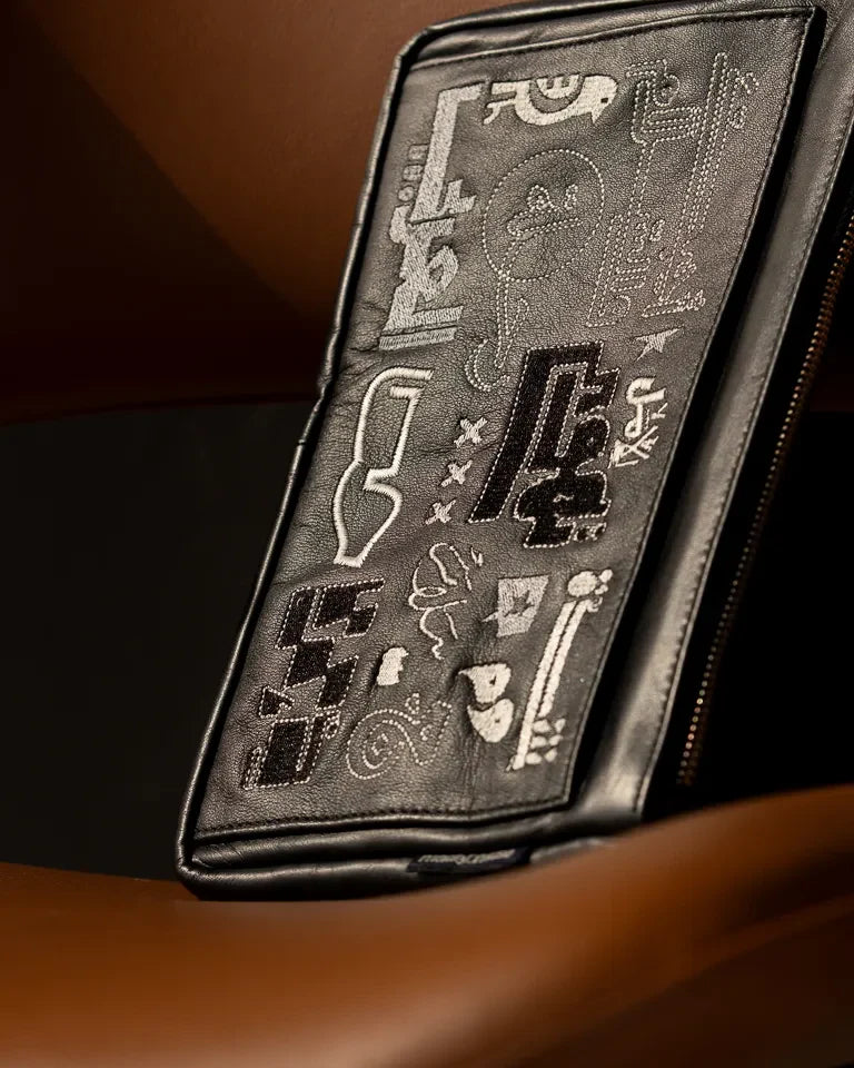 Fragments Leather Pouch by Ibrahim Zaki — handmade calfskin leather pouch with embroidered Arabic calligraphy