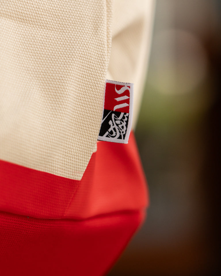 Monumental Handbag, Red by Wissam Shawkat — structured canvas handbag with bold red Arabic calligraphy stroke