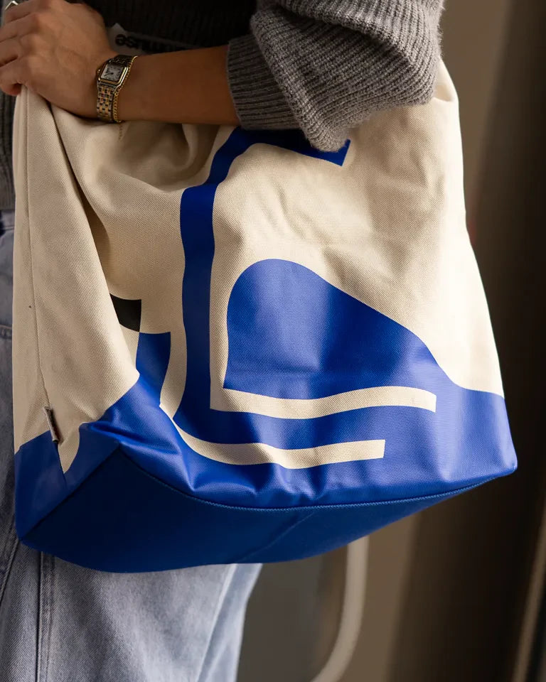 Monumental Handbag, Blue by Wissam Shawkat — structured canvas handbag with flowing blue Arabic calligraphy