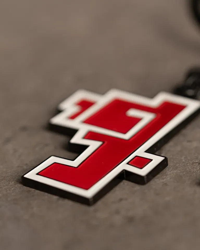 Hob Keychain by Ibrahim Zaki — enamel keychain with the Arabic word Hob in bold geometric calligraphy