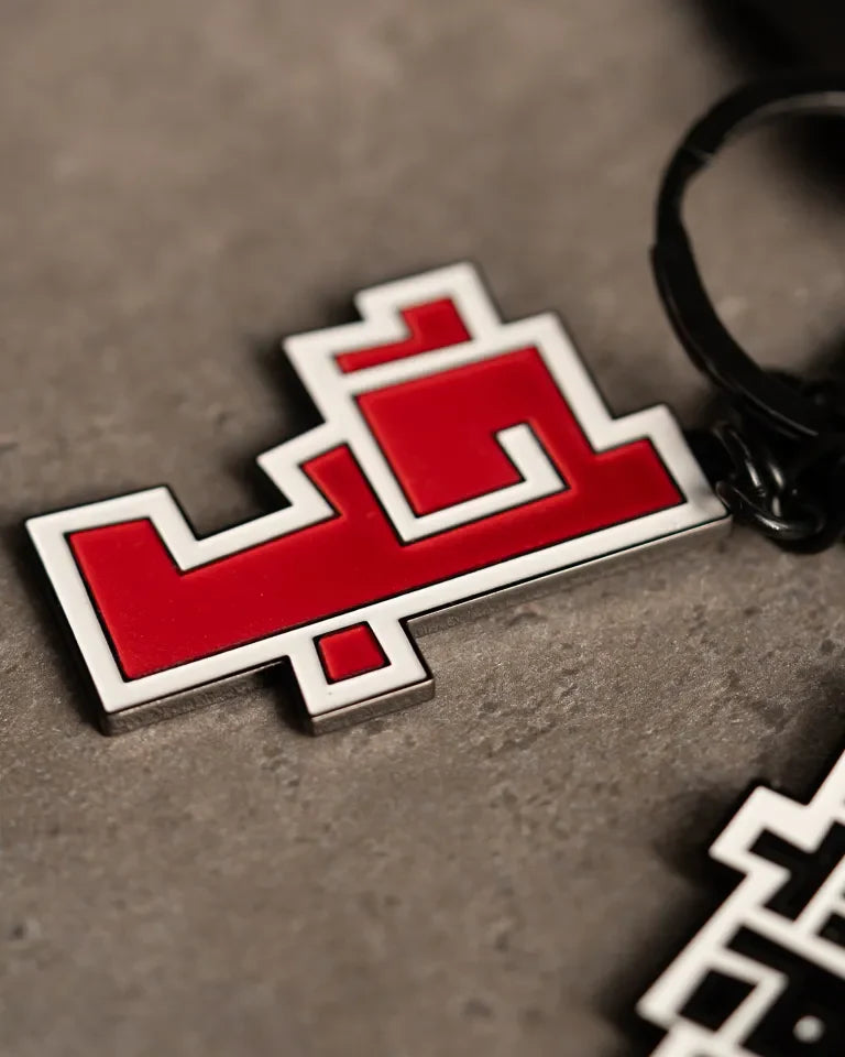 Hob Keychain by Ibrahim Zaki — enamel keychain with the Arabic word Hob in bold geometric calligraphy