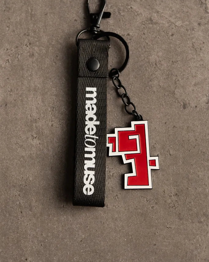 Hob Keychain by Ibrahim Zaki — enamel keychain with the Arabic word Hob in bold geometric calligraphy