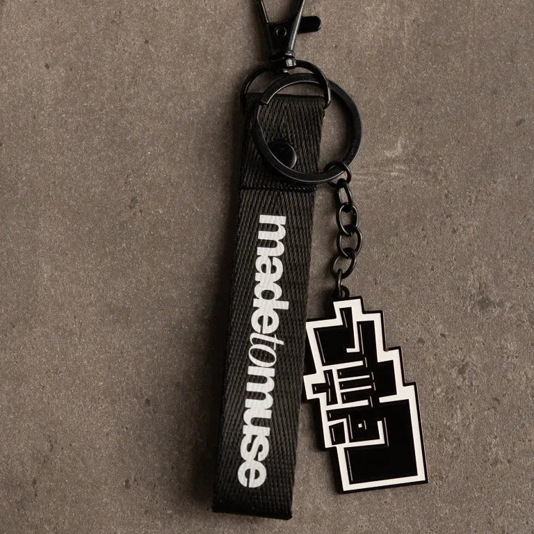 Ishq Keychain by Ibrahim Zaki — enamel keychain with the Arabic word Ishq in dense geometric calligraphy