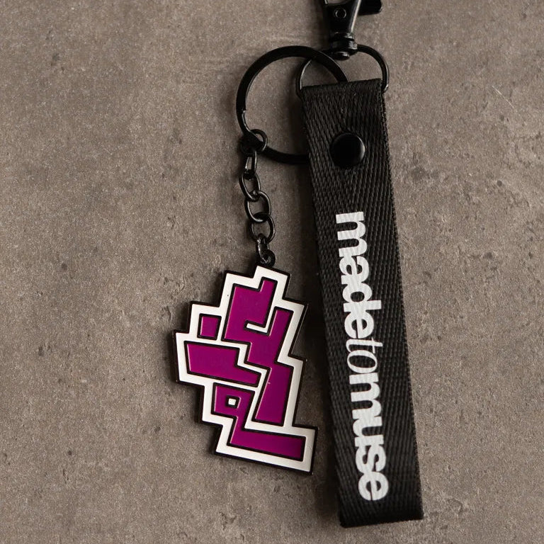 Gharam Keychain by Ibrahim Zaki — enamel keychain with the Arabic word Gharam in angular calligraphy on matte black