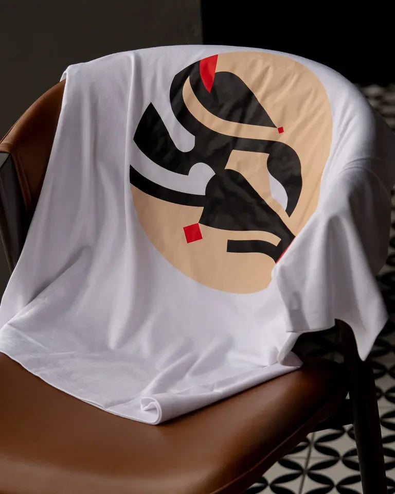 Eternal Tee by Wissam Shawkat — white cotton t-shirt with black Arabic calligraphy in circular composition with red accents