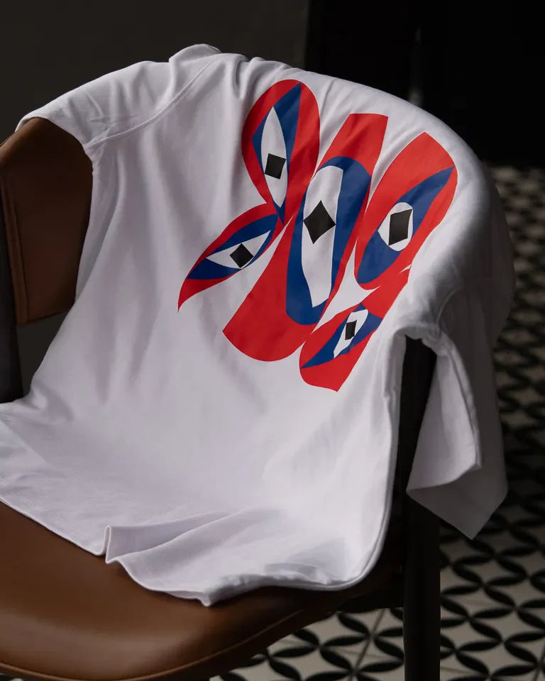Inside Outside Tee by Wissam Shawkat — white cotton t-shirt with bold red and blue Arabic calligraphy graphic