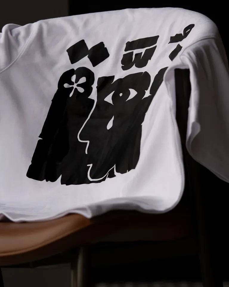 Ghosseh Tee by Ibrahim Zaki — white cotton t-shirt with embroidered Arabic calligraphy expressing layered emotion