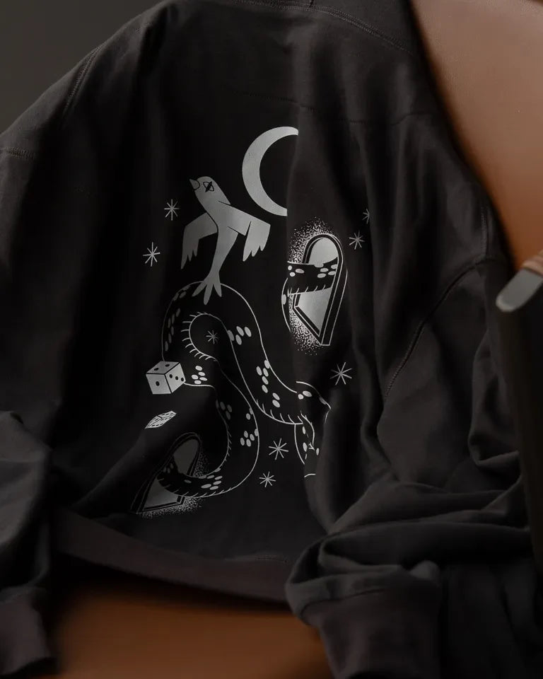 Snake Eyes Hoodie by Naji Al-Ali LMNBCK — black premium cotton hoodie with monochrome LMNBCK graphic illustration